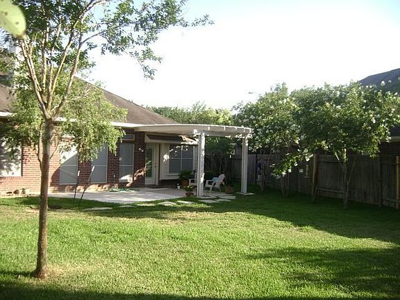 Rear of house w/ covered patio all 4 side brick