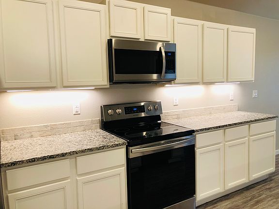 Beautiful all granite kitchen with stainless steel appliances.