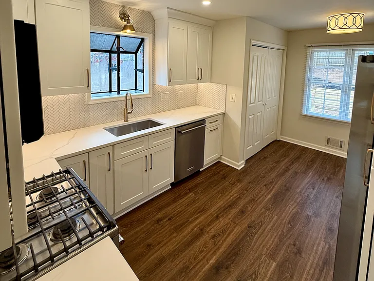 Freshly remodeled kitchen with stainless steel appliances and quartz countertops