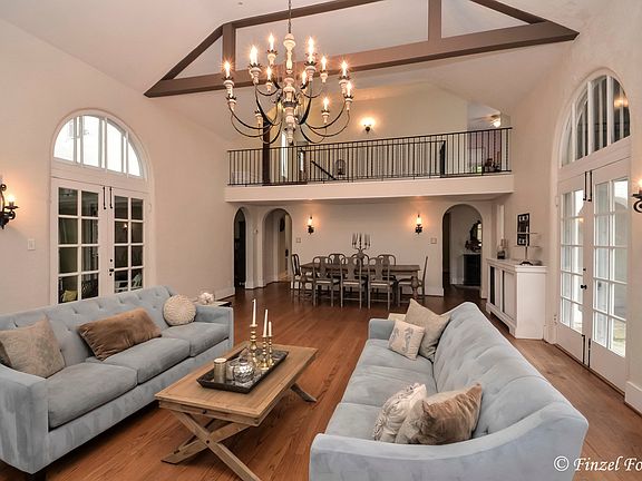 Amazing great room with fireplace. French doors flank both sides of room (to patio, and sunroom.)