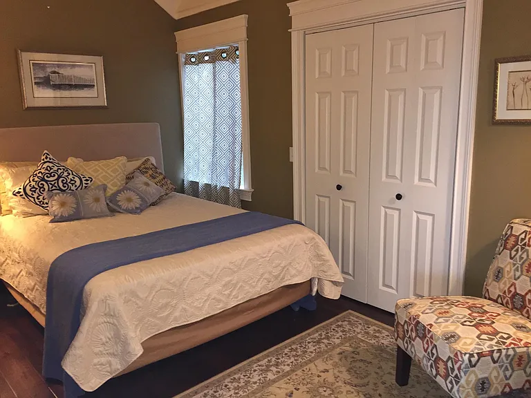 2nd Queen bedroom has ensuite private bath, clothes bureau, plenty of hanging and shelf storage in the closet.