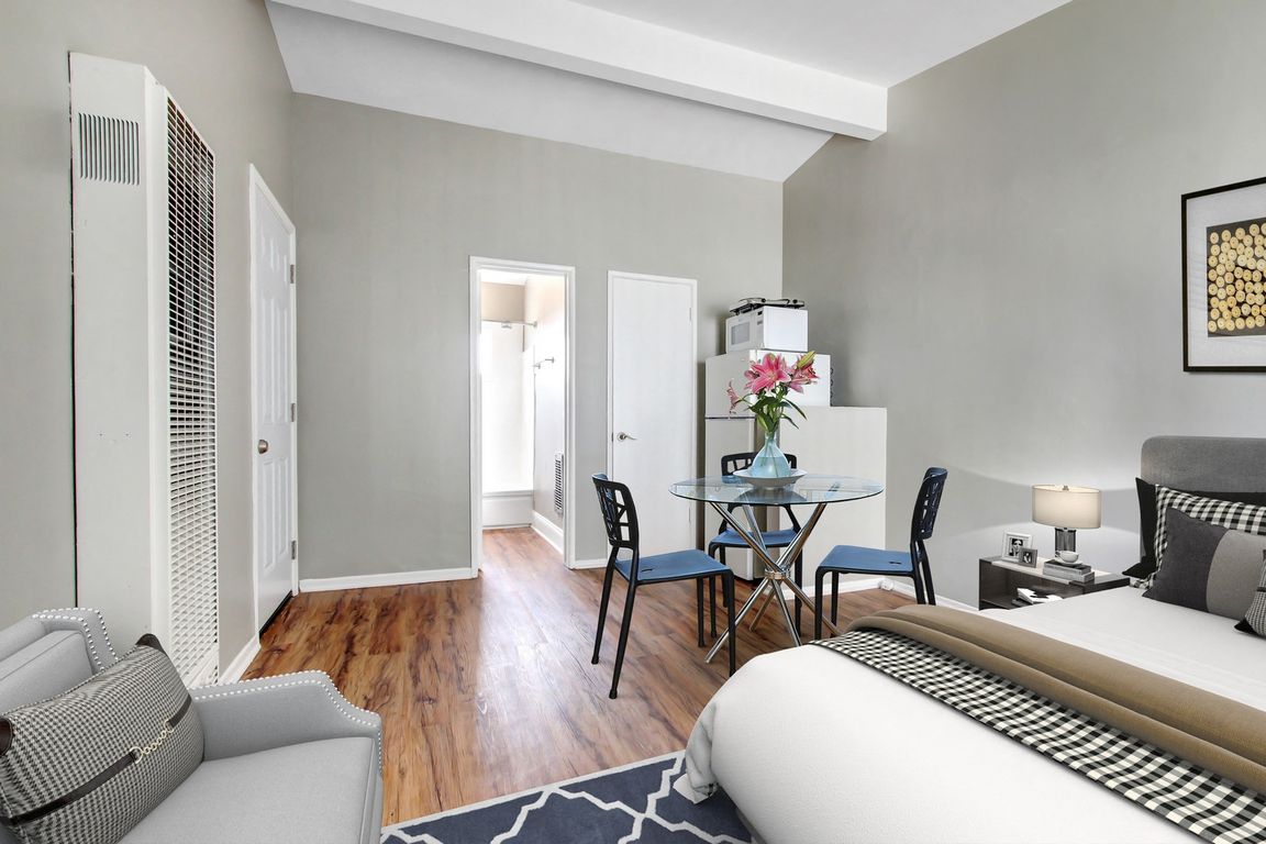 Efficiency no Full Kitchen, White refrigerator and microwave, wood-inspired floors sleeping and dining area