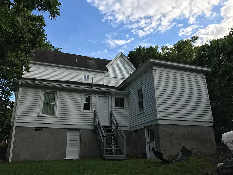 Back door and stairs. Much storage under house. Large grassy yard, lots of parking. Lots of privacy.