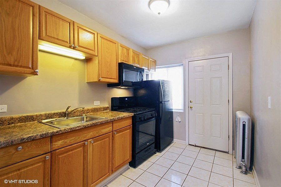 Bright kitchen with black appliances