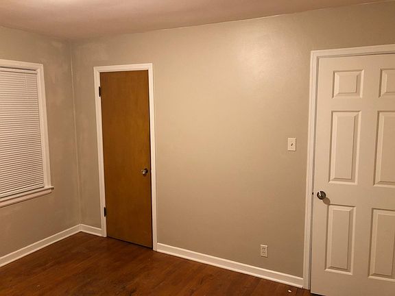 First bedroom with hardwood floors.