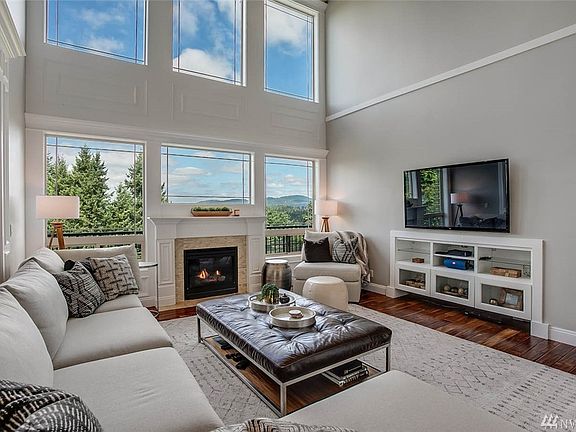 In the heart of the home is a light-filled great room with a wall of windows beckoning the distant foothills to become one with the indoor space