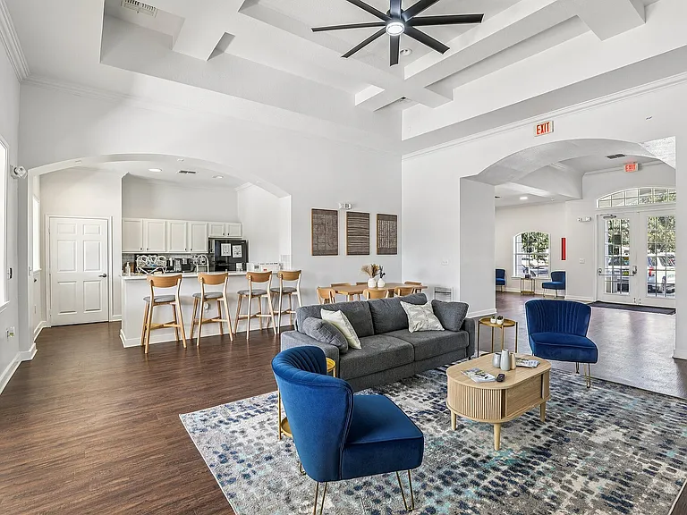 Spacious open-concept living area with modern kitchen, elegant seating, and bright natural light.