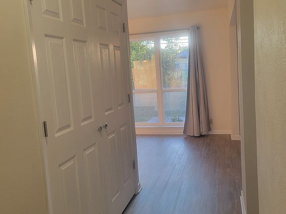 Front Hall showing living room in rear and laundry closet in hall