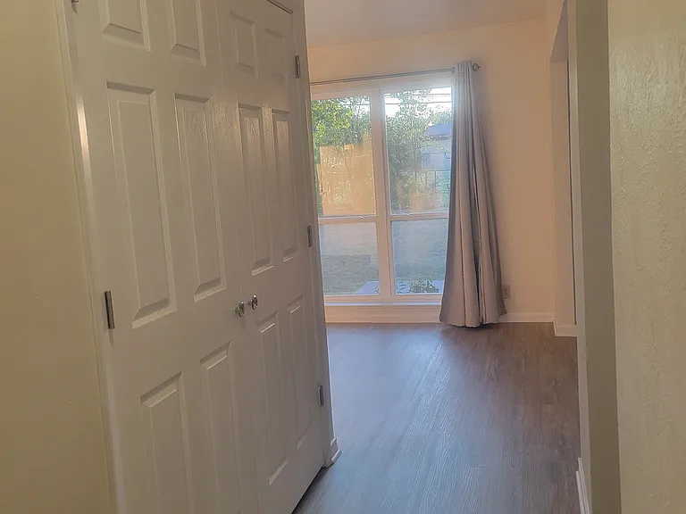 Front Hall showing living room in rear and laundry closet in hall