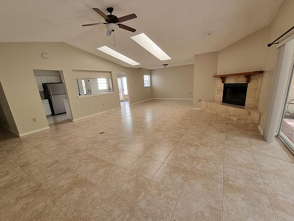 Large family room with skylights and wood burning fireplace