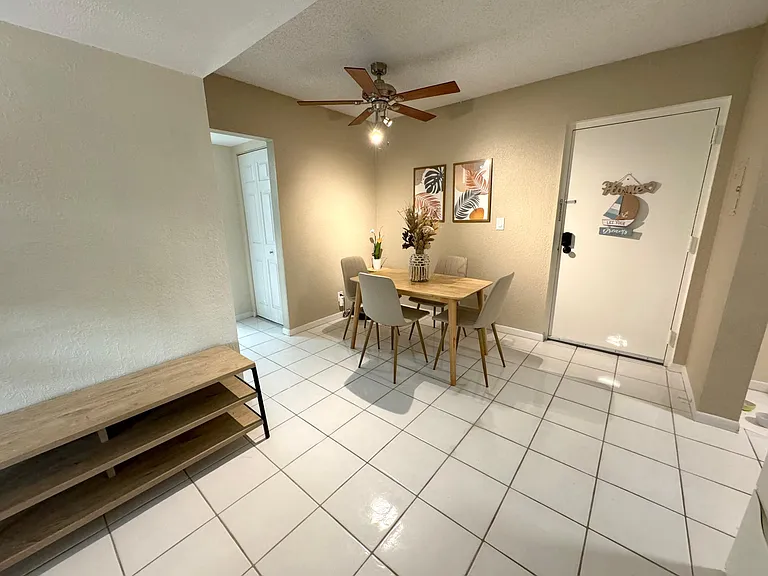 Dining room view with extra storage and front door entrance from hallway