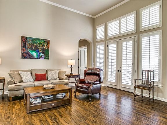 Spacious family room has beautiful hand-scraped hardwood floors and Plantation Shutters.  The windows view out to the backyard patio