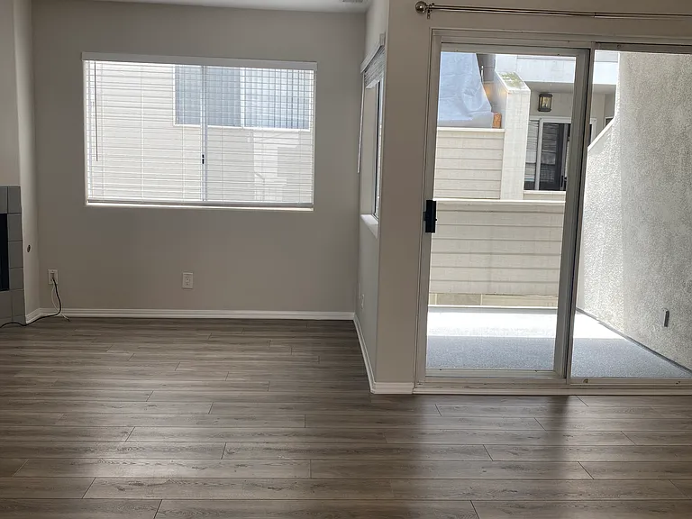 Large Living, Dining Area with Gas Fireplace and Access to Patio