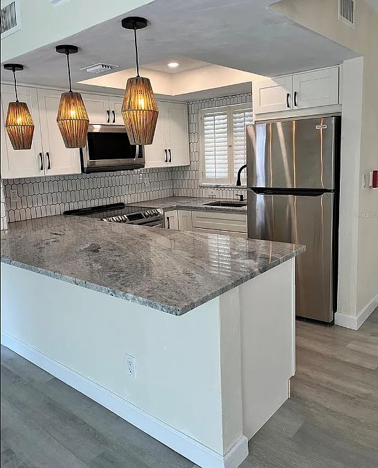 Renovated kitchen with new appliances. Room for bar stools.