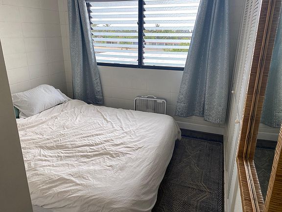 Smaller bedroom, shown with a california king bed