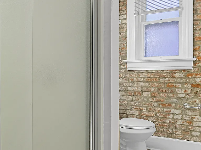 Bathroom view featuring tile flooring and a shower enclosure