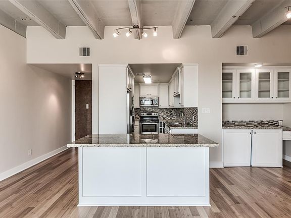 Large kitchen Island and open floor concept make this the perfect entertaining center. Clean bright walls with glass front cabinetry. Entry door located to the left in photo.