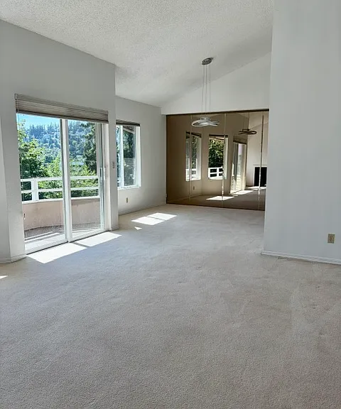Living room with lake view and dining space at other end