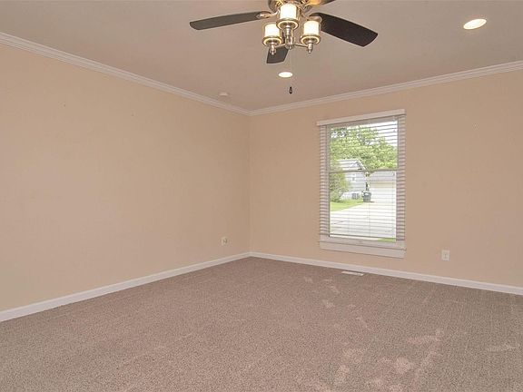 Living Room -- crown molding, new ceiling fan, new carpet, fresh paint, new can lights.