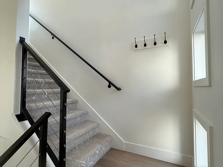 Stairs leading to the bedrooms and laundry.
