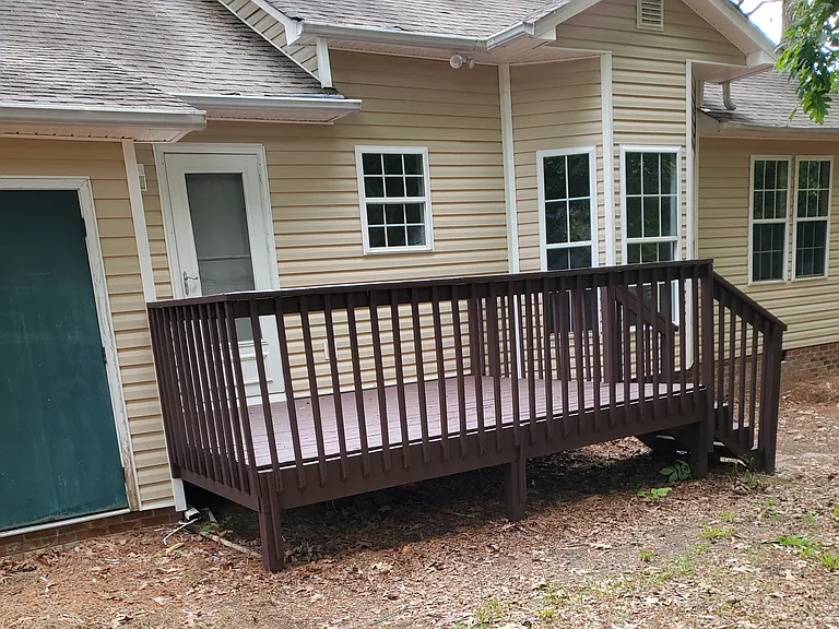 Nice deck in backyard & storage area.
