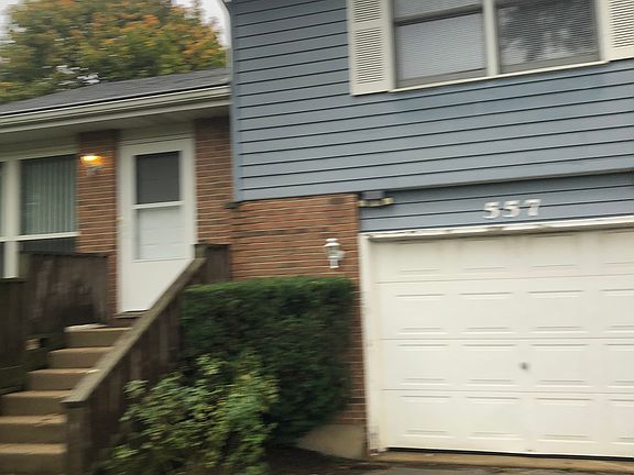 557 
Front door and garage door, primary bedroom window