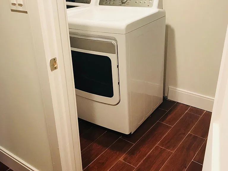 Private entrance to laundry room from living room hallway