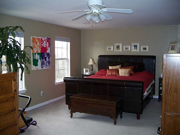 Giant master bedroom with walk in closet, sitting area and attached tile bath.