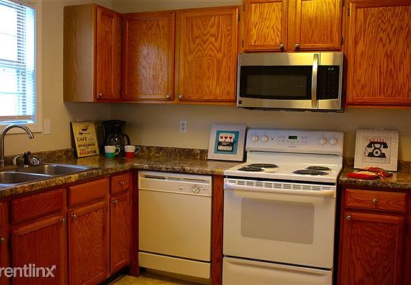 Kitchen features refrigerator, stove, oven, dishwasher and m