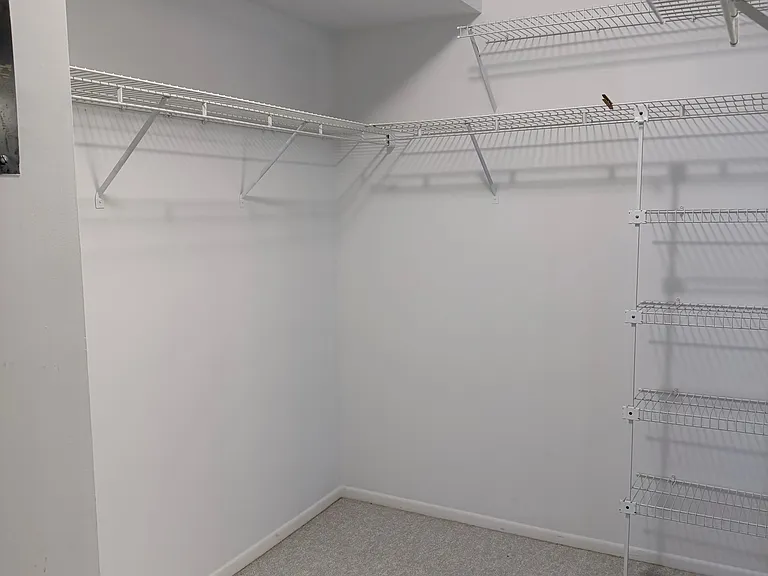 One side of HUGE Primary walk-in closet
