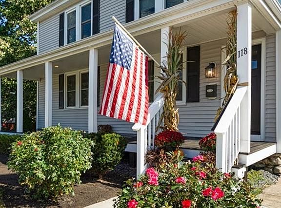 Front entrance and porch. Featuring a nicely landscaped lawn.