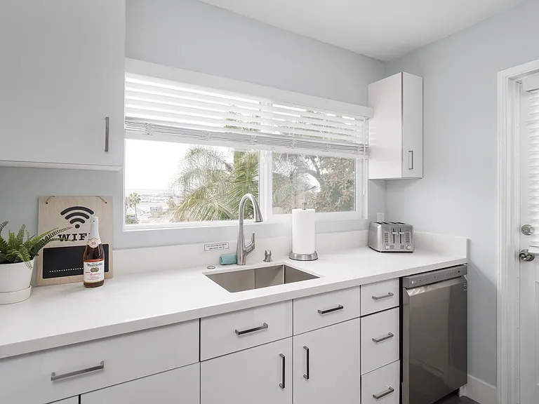 Fully stocked kitchen with stainless steel appliances.