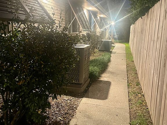 Private side entrance featuring secure access and a convenient walkway for added privacy.