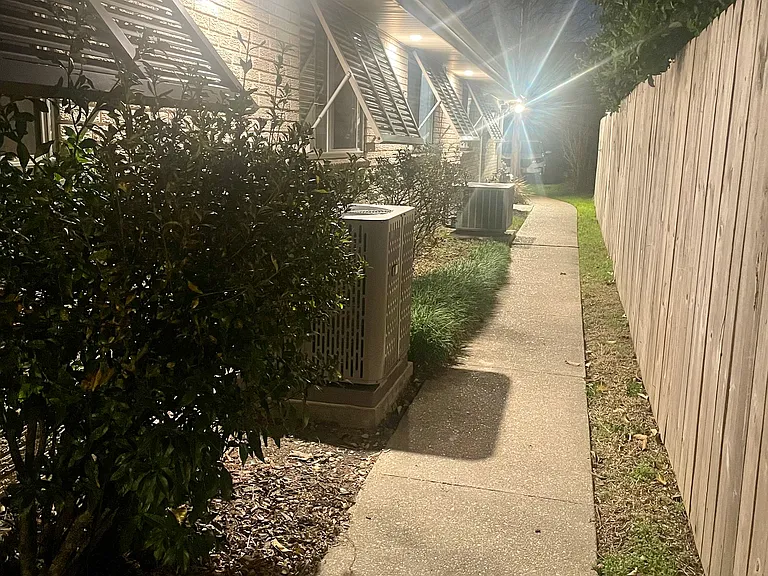 Private side entrance featuring secure access and a convenient walkway for added privacy.