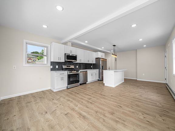 VIEW OF LIVING ROOM AND KITCHEN-OPEN