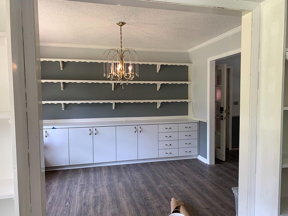 Dinning room with open door through the kitchen on the right of the picture.