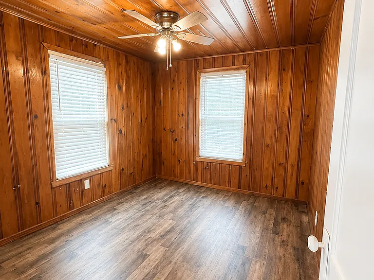 Bedroom #2 - Original wood retained for historic preservation. New windows, flooring, and ceiling fan. 

Photo Note: Photos have been lightly enhanced to improve lighting and image quality. Colors, finishes, and exterior conditions may vary slightly.