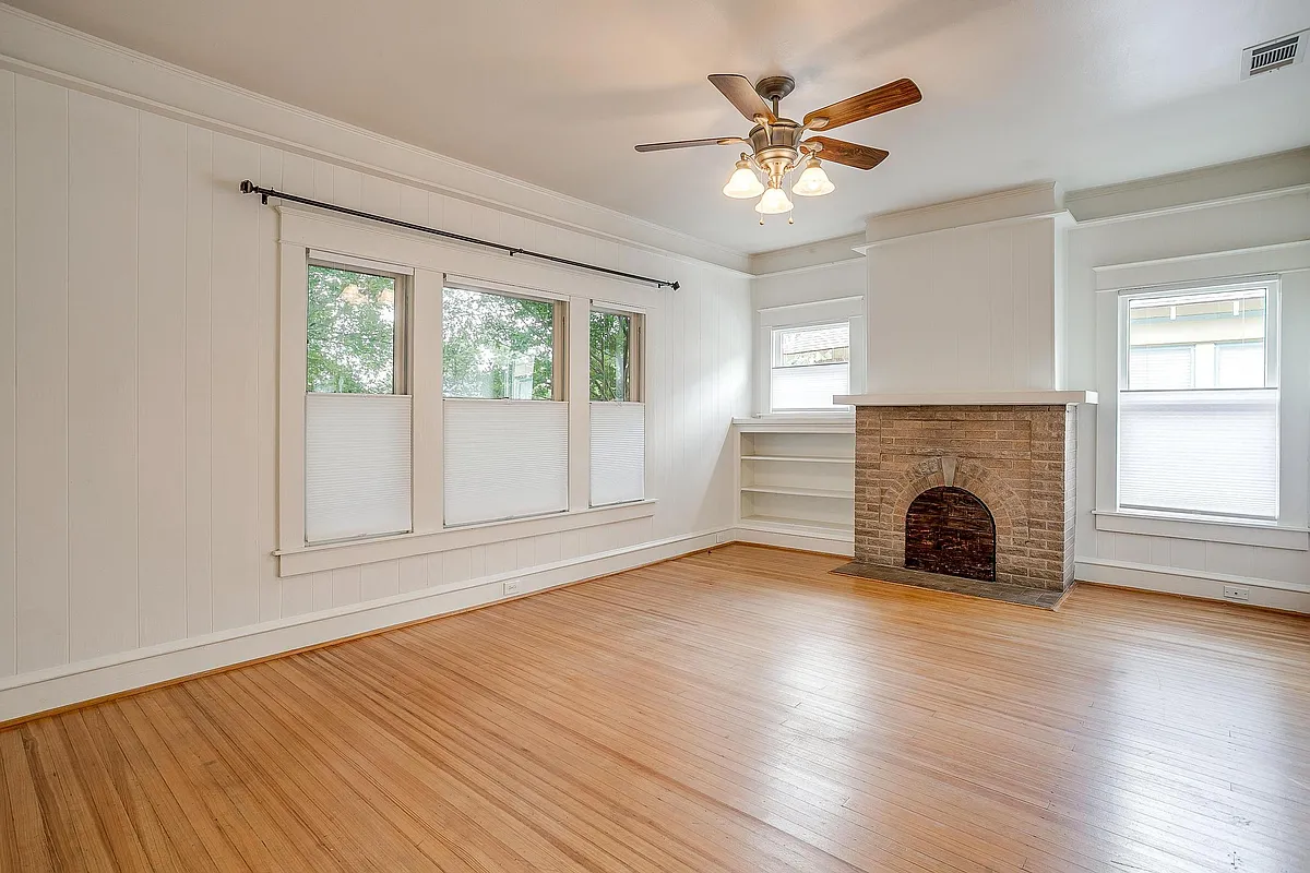 Enter into the living room with adorable fireplace and built in shelves. - 402 N Marlborough Ave
