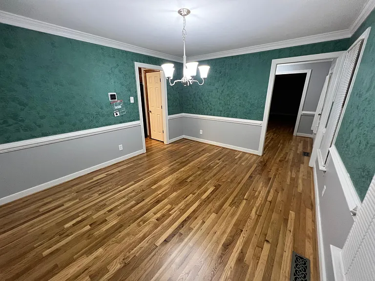 Dining room looking at the front entry way on the right and entry to kitchen on the left