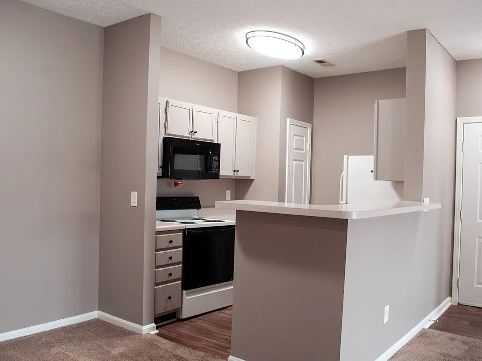 Fully equipped kitchen with modern cabinetry + breakfast bar