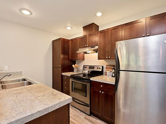 Gourmet kitchen with granite countertops, cherry cabinets, stainless-steel appliances.
