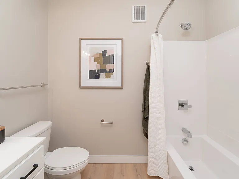 A functional bathroom layout with tub and shower combination.