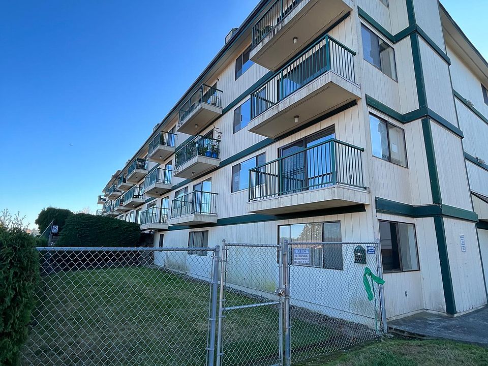 view of building from back. Corner unit with balcony