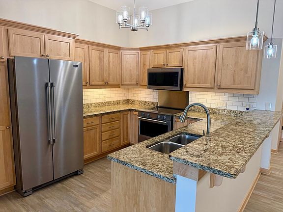 Plenty of storage in this kitchen with roll out shelves in the pantry and gorgeous maple cabinets