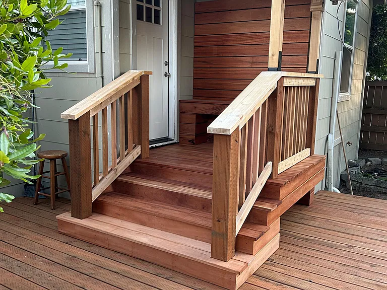Brand-new Brazilian Tigerwood hardwood entry deck with inlaid bench and backrest.