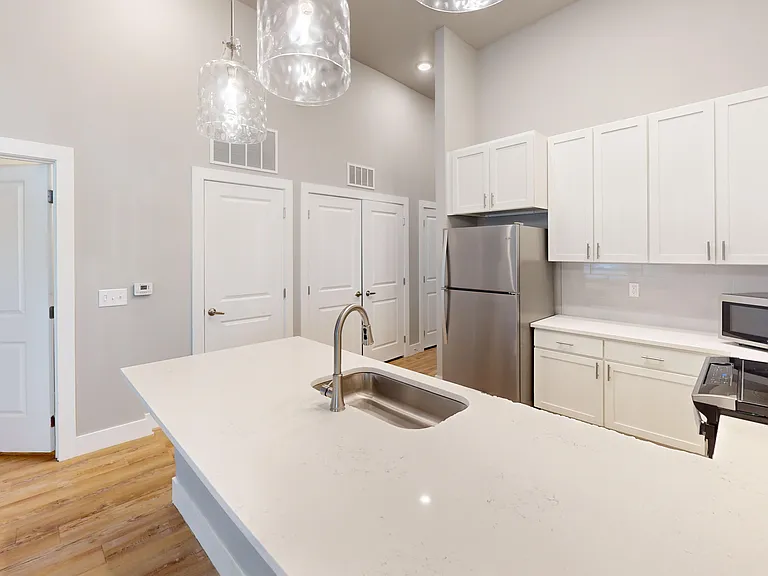 The Bellview kitchen includes ample counterspace and opens to a half-bath, hallway, and access to the in-unit washer and dryer. The Bellview kitchen includes ample counterspace and opens to a half-bath, hallway, and access to the in-unit washer and dryer.