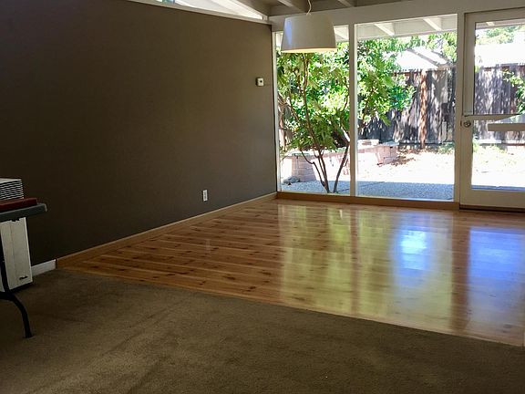 Standing in living room looking toward dining area and backyard