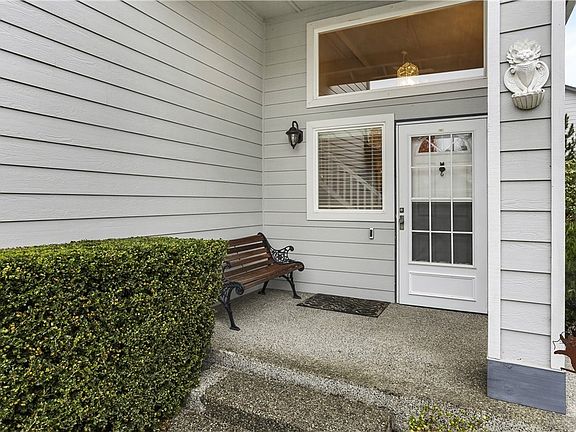 Awesome front porch is fully covered so your guests stay warm and dry!  Notice the Ring-brand doorbell and storm door that are both included.  Large windows here provide architectural interest and allow in natural light!