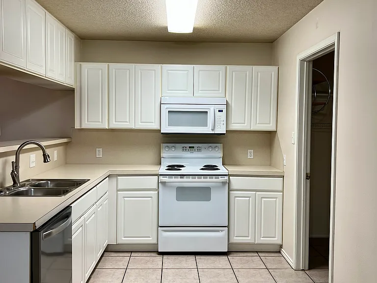 Open Kitchen, comes with microwave, stove, dishwasher, goose neck sprayer faucet, and garbage disposal. It already has a water hookup for an ice/water dispensing refrigerator (tenant must supply).