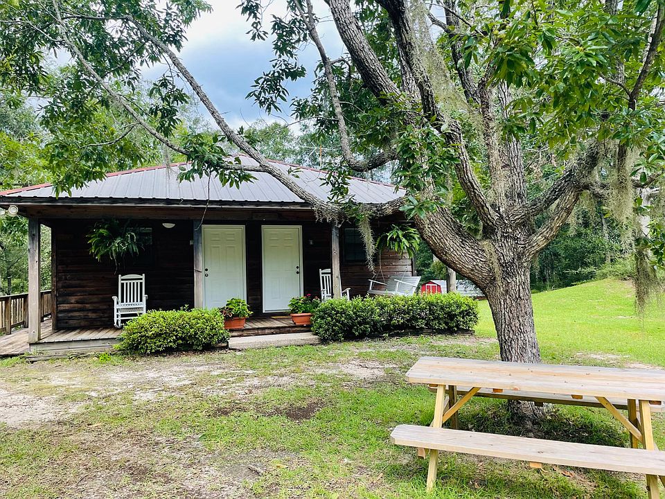 Front of cottage/single family house 2 front doors Surrounded by trees picnic bench secluded